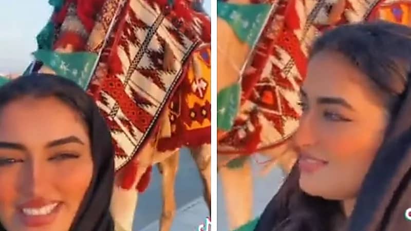 ‏فتاة تتجول برفقة جمل في اليوم الوطني .. فيديو