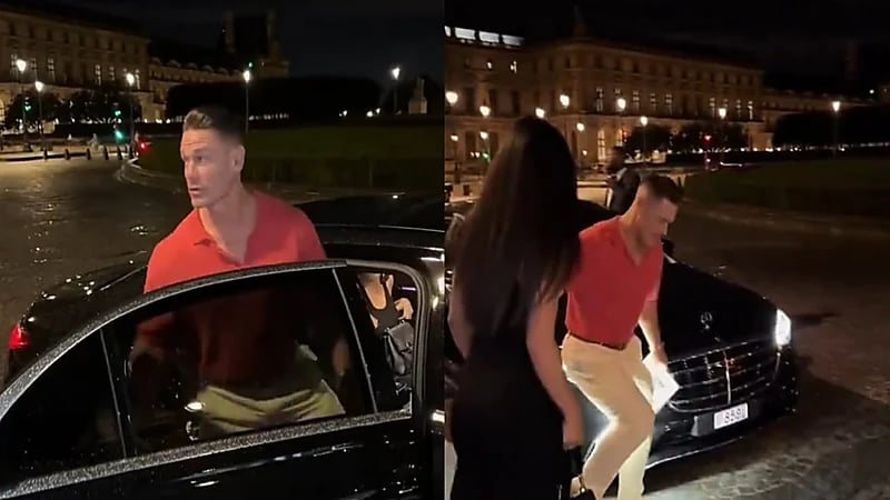 جون سينا يرفع زوجته بيد واحدة لكي تتجنب بركة مياه بالطريق.. فيديو